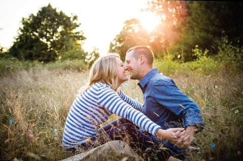 engagement photo of couple in a field