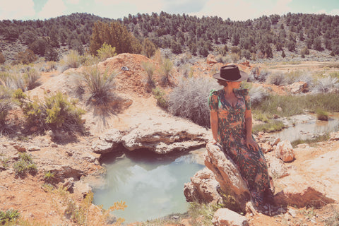 girl in dress wearing hat in desert