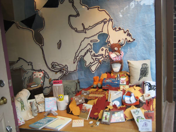 Scout Roncesavalles storefront window with map of Canada installation