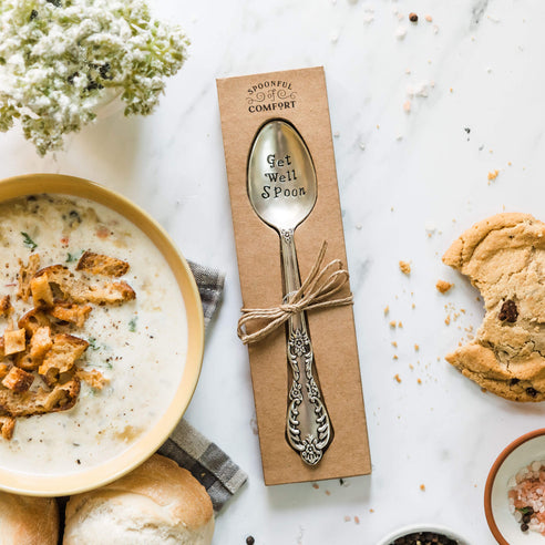 Printed get well spoon. Surrounded by decorative props