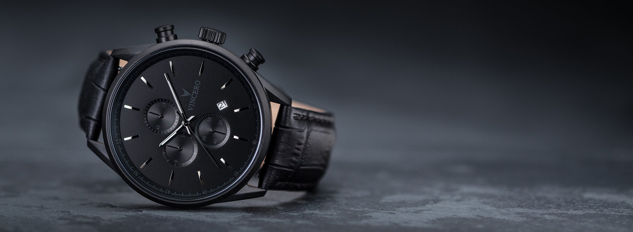 Close up of matte black watch in greyish black background