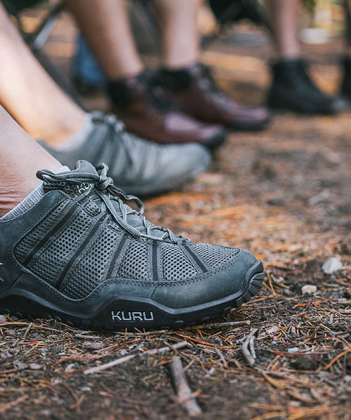 Man wearing KURU CHICANE trail hiking shoes in EmpireSteel-Black-Basalt camping with his friends