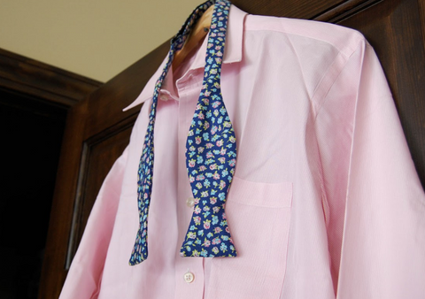 Floral bow tie styled with a pink dress shirt