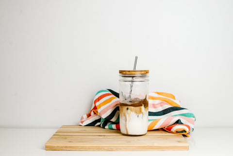 whipped coffee in a 24 oz mason jar with a sustainable bamboo lid and stainless steel reusable straw