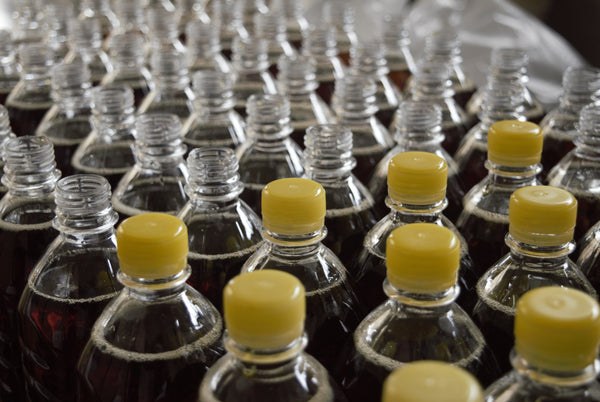 mass market production of plastic pop bottles with yellow plastic lids