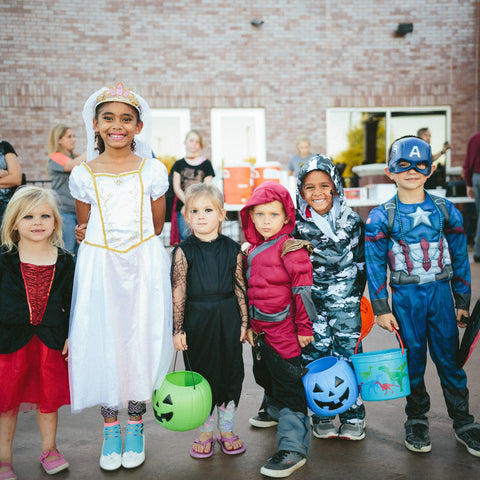 Group of kids wearing Halloween costumes source: Unsplash