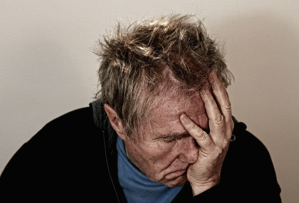 image of an older man suffering from some sort of head pain