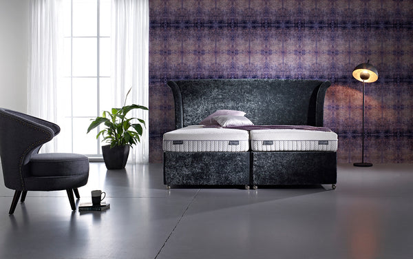 Purple bedroom wallpaper from Blackpop sets off this tempting Dunlopillo Firmrest bed