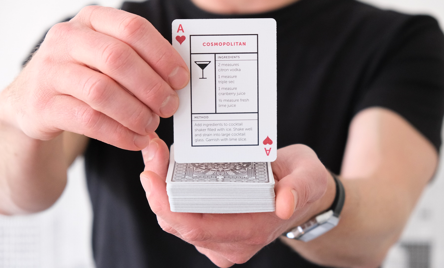 COCKTAIL CARDS Holding up Cosmopolitan card