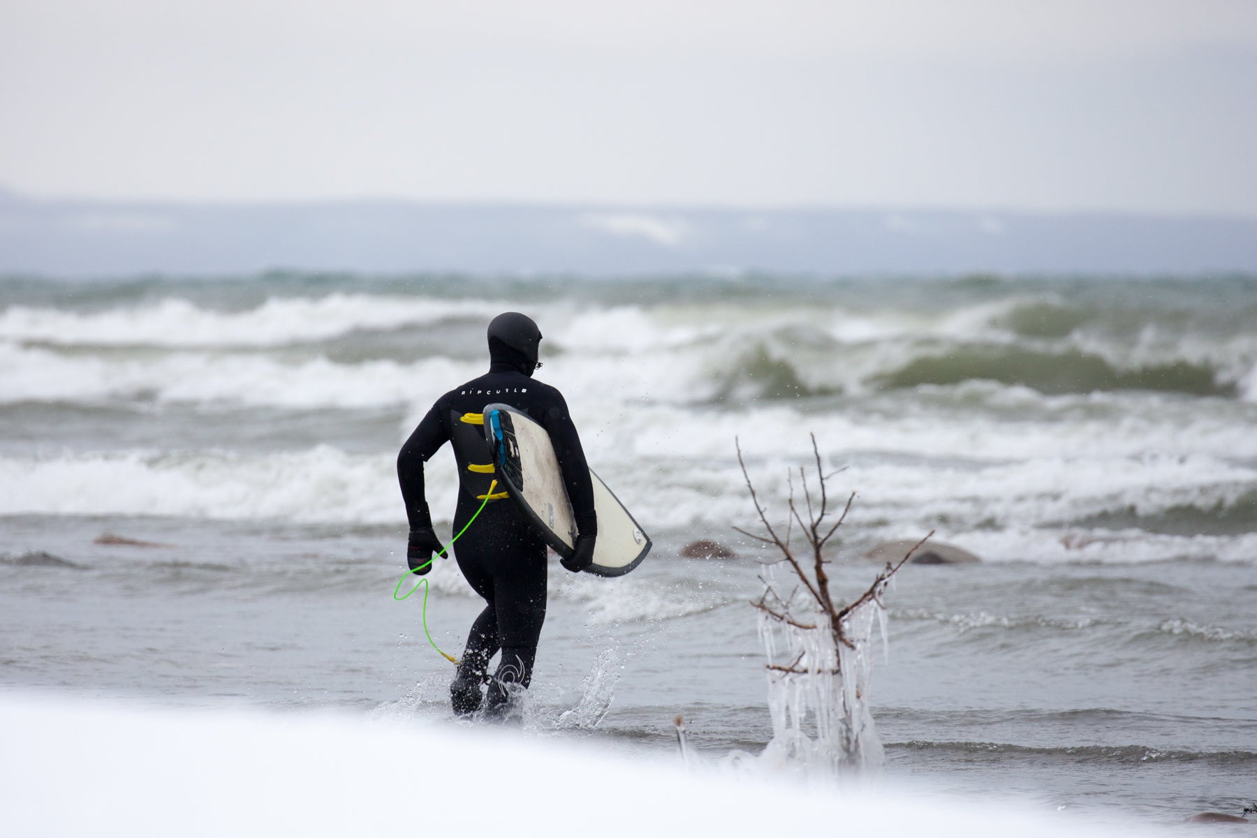 Surfing on the Great Lakes in Ontario during a winter snow storm