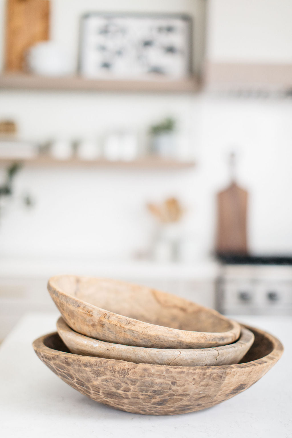 greige design shop + interiors alexandria project light grey cabinetry brass hardware carved wood bowls