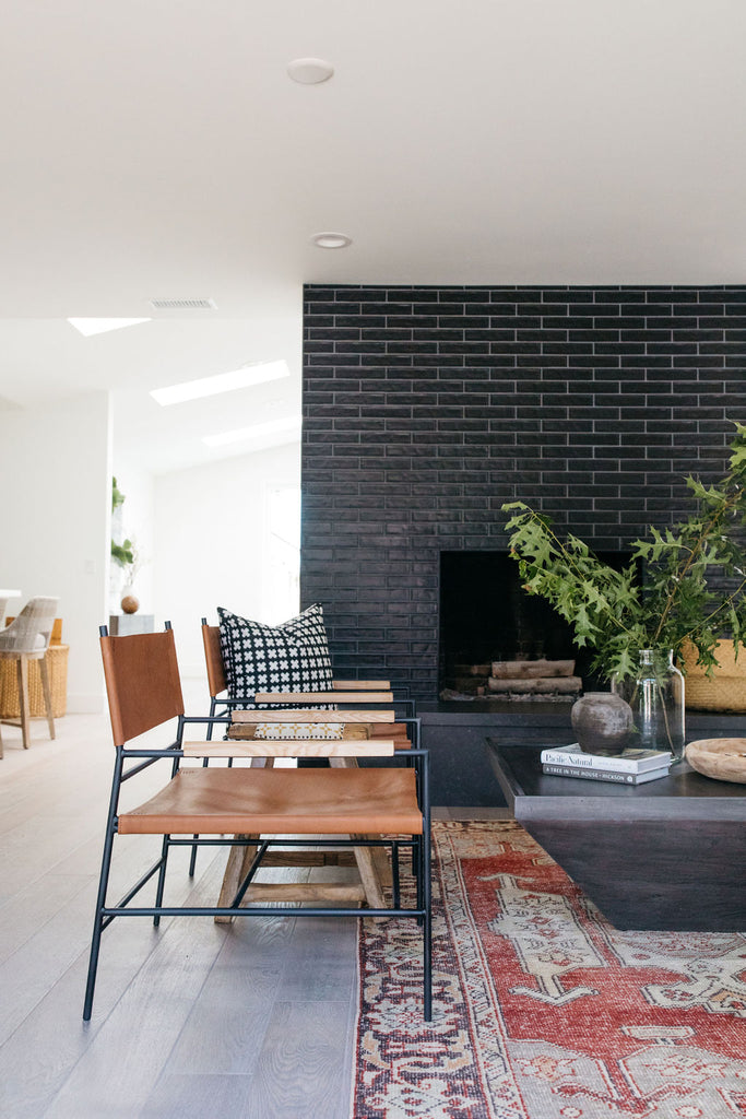 greige design shop + interiors alexandria project san diego california beach house black stacked tile fireplace living room design