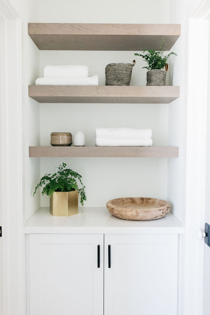 greige design shop + interiors alexandria project san diego california beach house linen storage open shelves  master bathroom design