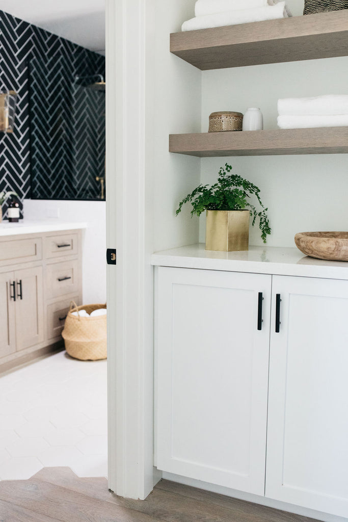 greige design shop + interiors alexandria project san diego california beach house black herringbone backsplash brass fixtures master bathroom design