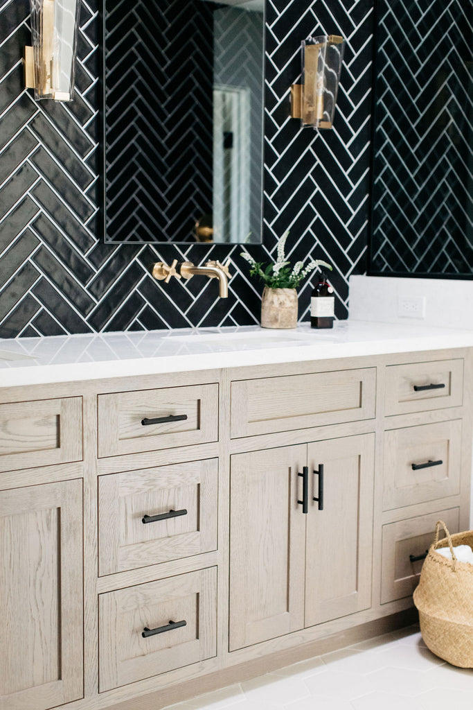 greige design shop + interiors alexandria project san diego california beach house black herringbone backsplash brass fixtures master bathroom design