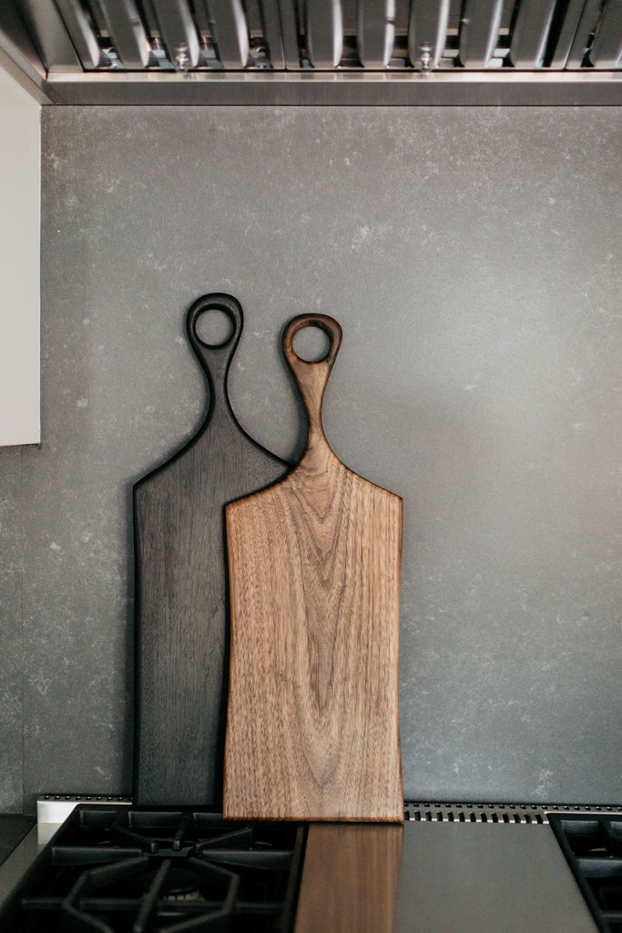 greige design shop + interiors albion project san diego california white kitchen black counters handmade walnut serving board
