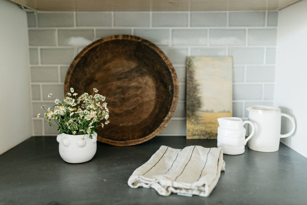 greige design shop + interiors albion project san diego california white kitchen black counters coffee station