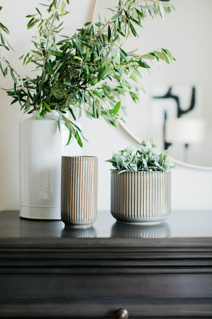 greige design shop + interiors grey and yellow bedroom habitat pot and white vase asconda chest round mirror