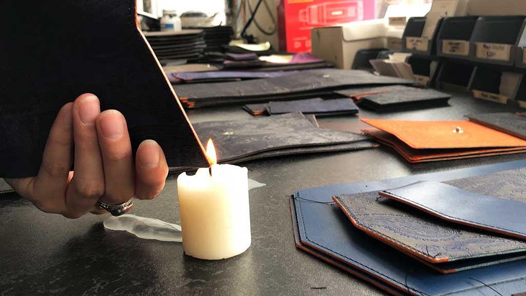 Thread searing with traditional leather workers candle