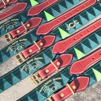 Boy-O-Boy Bridleworks custom satin and grosgrain Stirrup Buckle belts with logo embroidery.