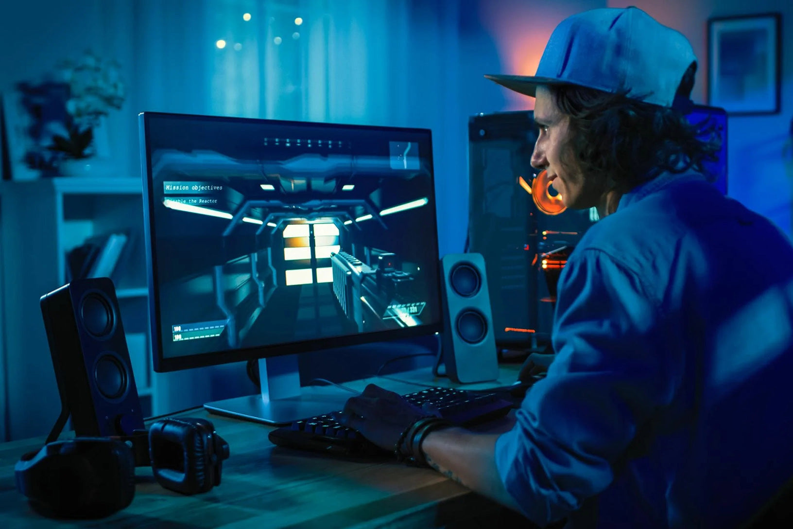 guy in cap playing pc video game