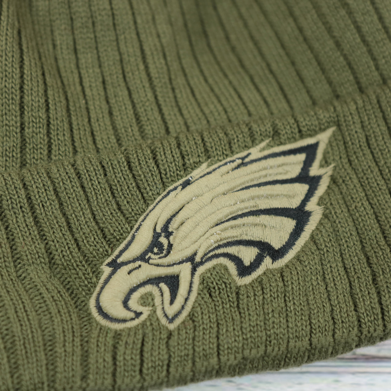 eagles logo on the Philadelphia Eagles Stars And Stripes Patch Salute To Service Ribbon NFL On Field Beanie | Olive Green Beanie