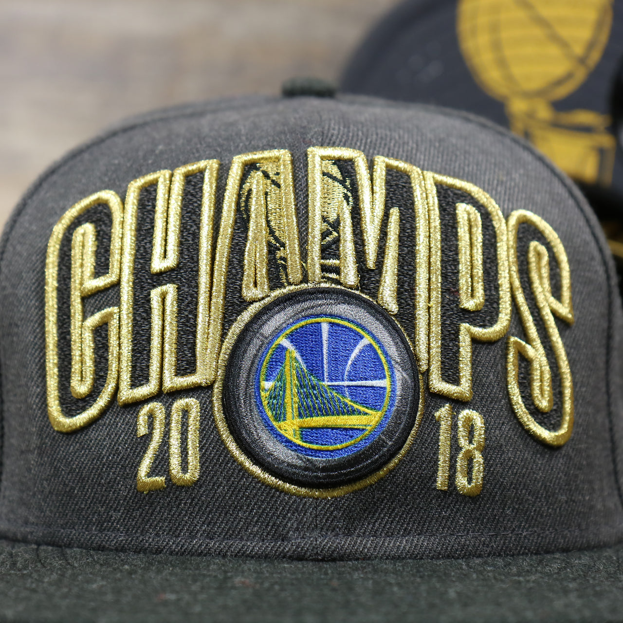 The Golden State Warriors and 2018 Champs Logo on the Golden State Warriors NBA Finals 2018 Champs Snapback Cap | Gray Snap Cap