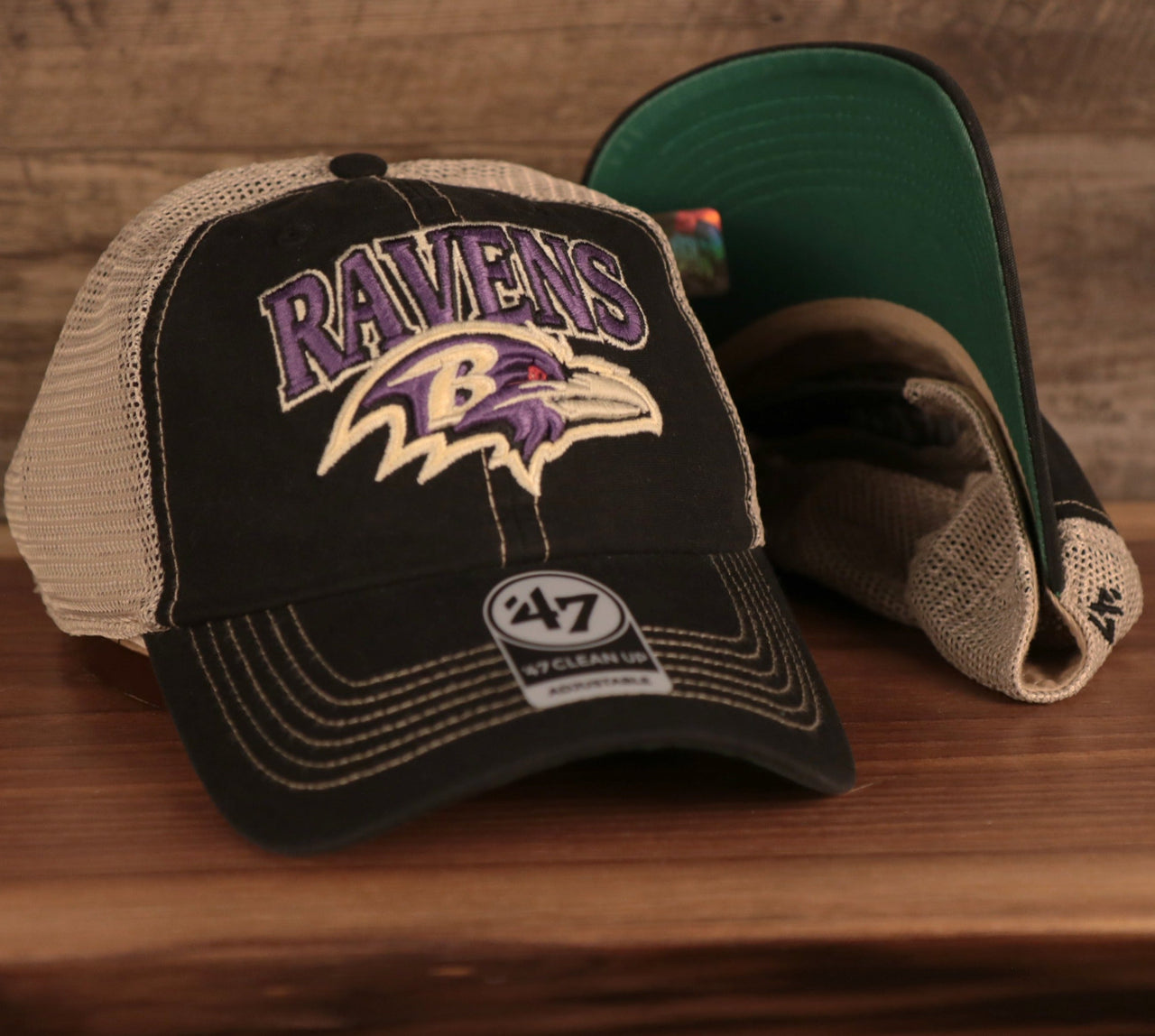 front and bottom of the Baltimore Ravens Black Adjustable Green Bottom Trucker Cap