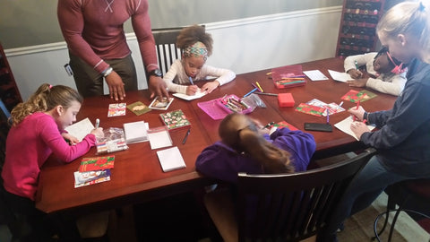 the girls preparing special Christmas cards for the Seniors
