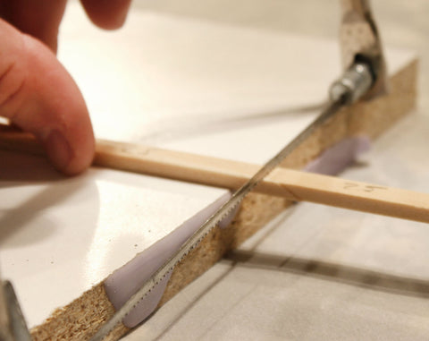 cutting miniature wood with hacksaw
