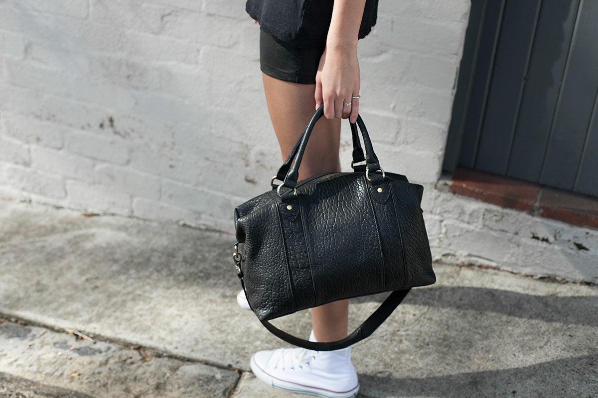 status anxiety leather handbags