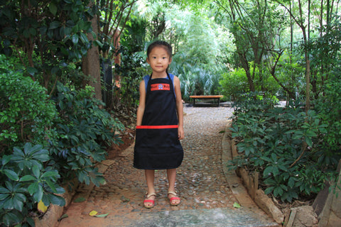 Hmong small child with Best Help apron