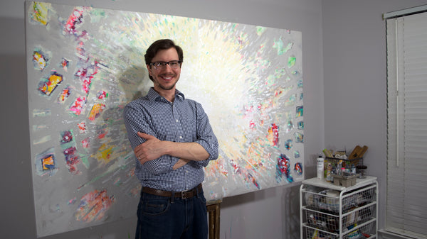 Stephen Lursen in front of his finished abstract painting