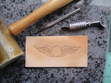 Hand carving wings on leather 1