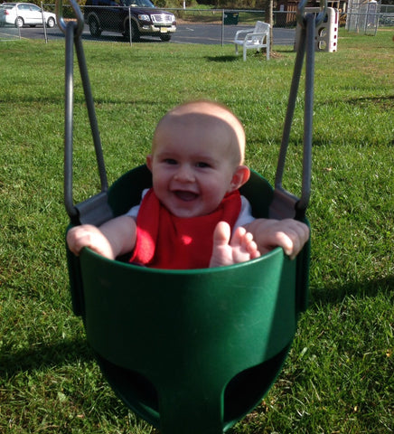 Adorable Kid in Bucket Swing