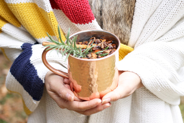 rose gold coffee mug with hudson bay stripe blanket log cabin