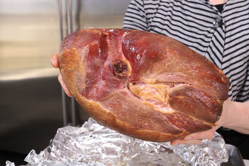 smoked ham held by chef