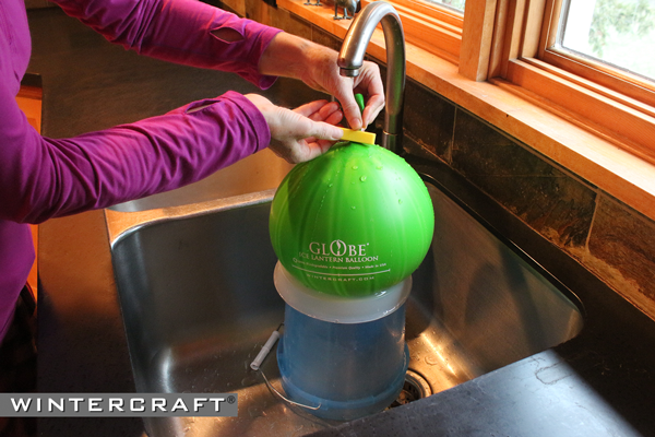 Secure the Wintercraft Globe Ice Lantern Balloon closed with a Easy-close Clip