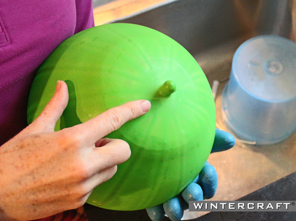 Use the hole in the bottom of the Globe Ice Lantern to determine the thickness of the ice