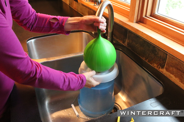 Use the pressure of the water from the faucet to fill Wintercraft Globe Ice Lantern Balloon with water