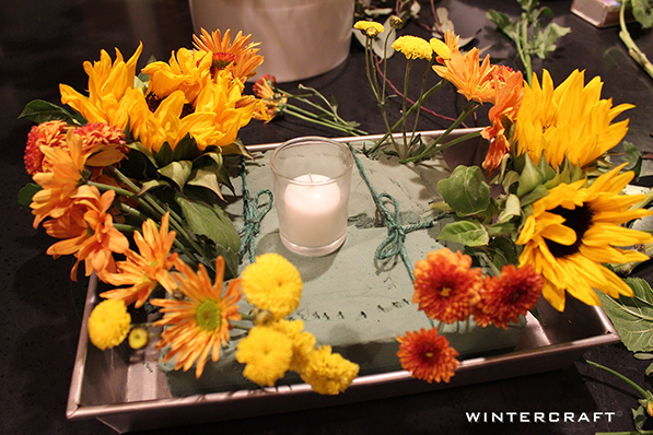 Add flowers to foam for centerpiece Wintercraft