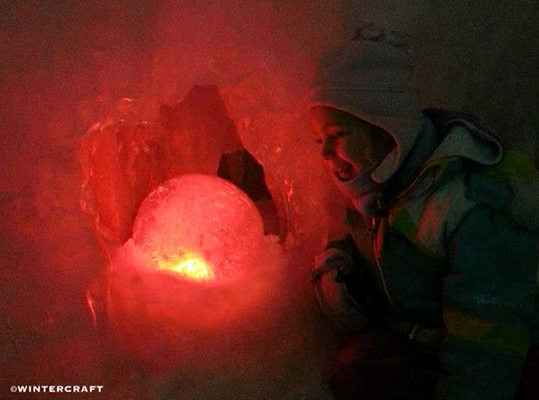 Girl looking at Wintercraft Globe Ice Lantern as Magic Dragon Egg