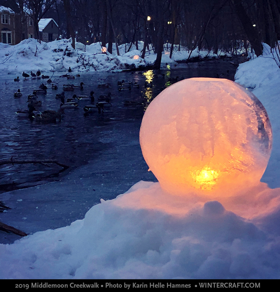 Globe ice lantern by creek w ducks 2019 Middlemoon Creekwalk photo by Karin Helle Hamnes