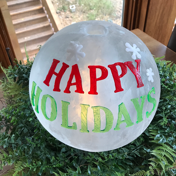 Happy Holidays message on frosted globe ice lantern Ice Wrangler Wintercraft