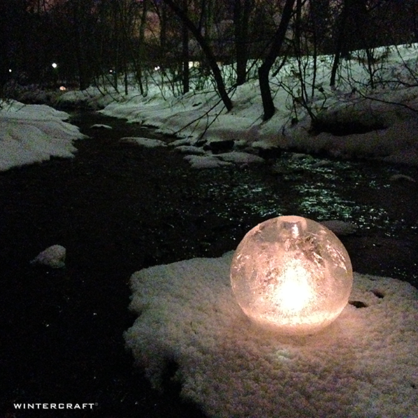 Wintercraft Middlemoon Creekwalk, spontaneous luminary lighting, solitary globe ice lantern lit on the sandbar