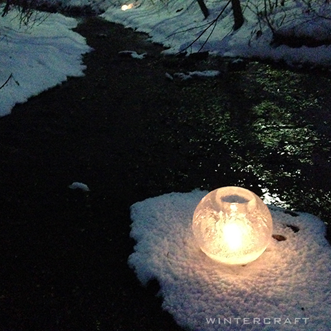 Wintercraft Romantic setting middlemoon creekwalk  globe ice lantern by creek