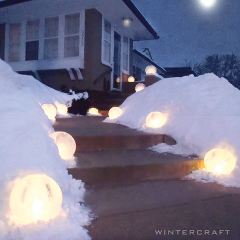 Wintercraft IceLantern  Front entry way lined with candle-lit spherical ice lanterns 