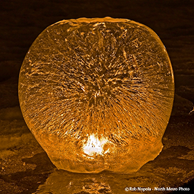 Old Sunkissed Globe Ice Lantern lit with candle - photo by Rob Nopola