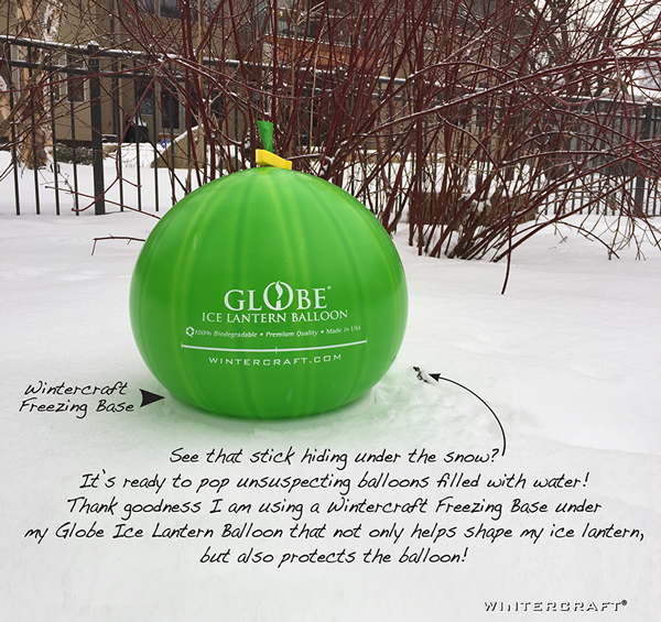 Wintercraft Globe Ice Lantern Balloon sitting in a Wintercraft Freezing Base surrounded by snow to insulate the bottom!