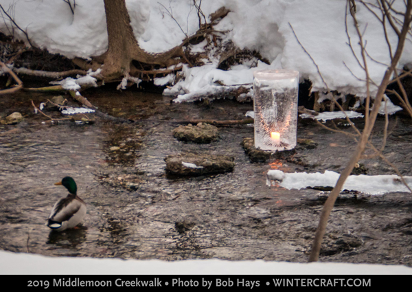 Tom placed a pillar ice lantern in the creek and lit it with a candle for 2019 Middlemoon Creekwalk. Photo by Bob Hays